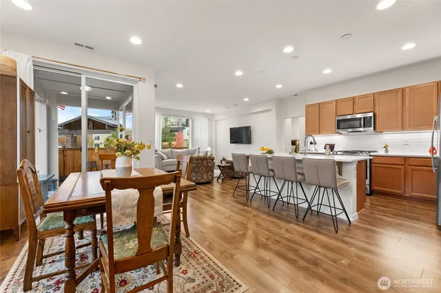a kitchen with a dining table chairs and view living room