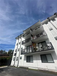 a view of balcony with furniture and a potted plant