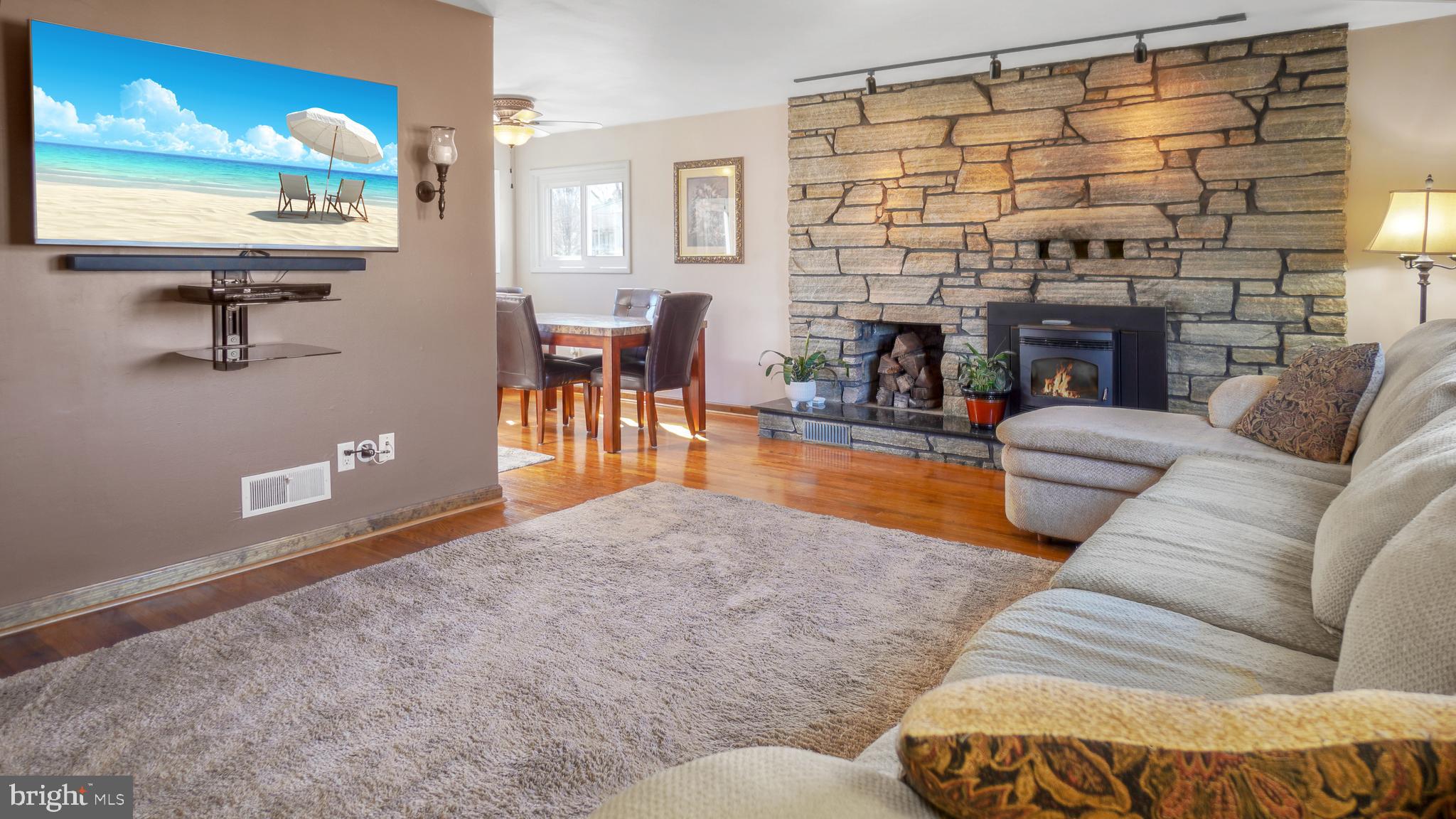 203 Ridgely Road Glen Burnie, MD 21061 - Photo 5 of 35 Living Room with feature wall/hearth and woodstove