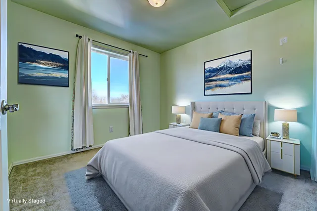 a bedroom with a bed and a painting on the wall