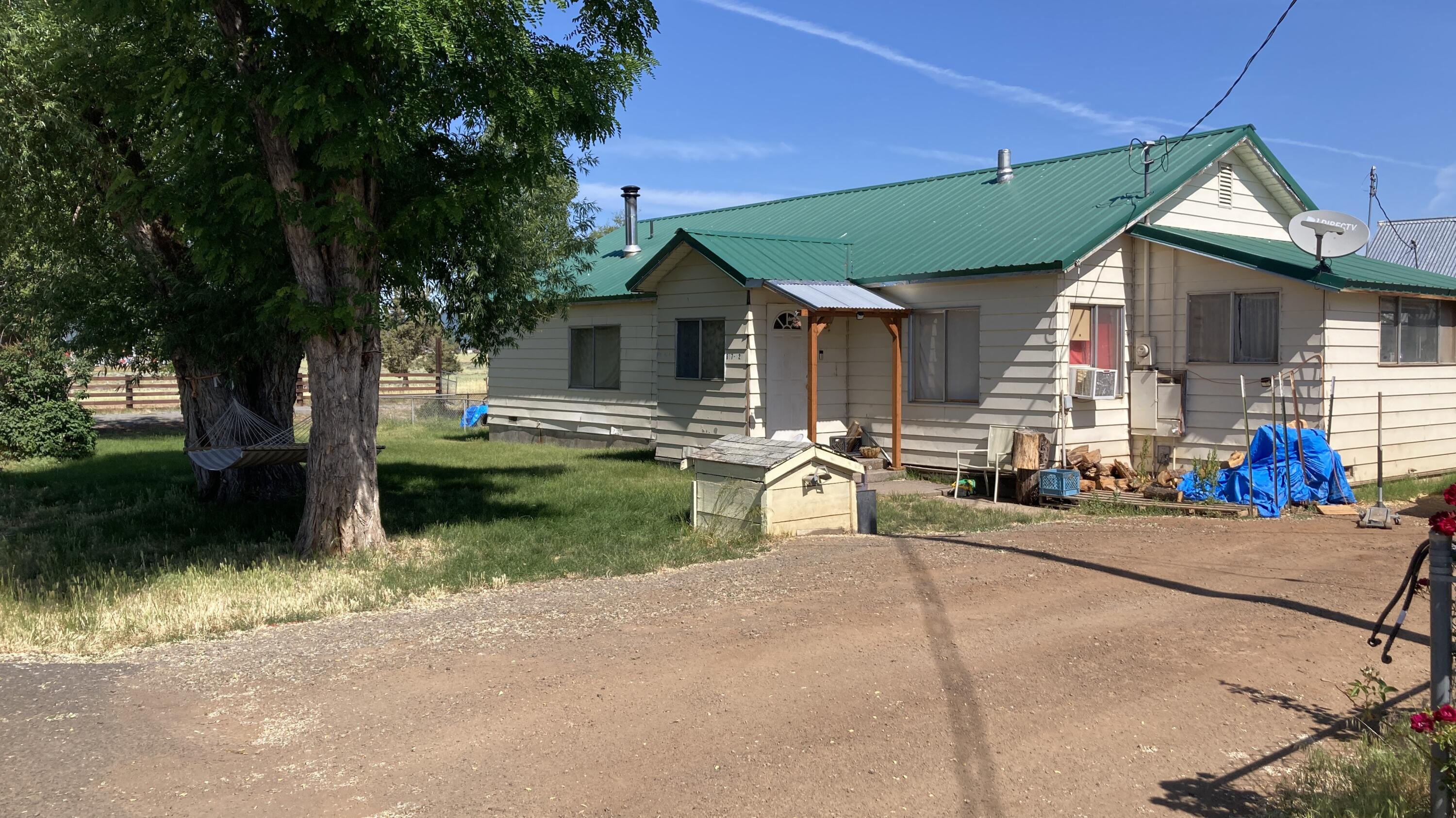 a front view of house with yard and outdoor seating