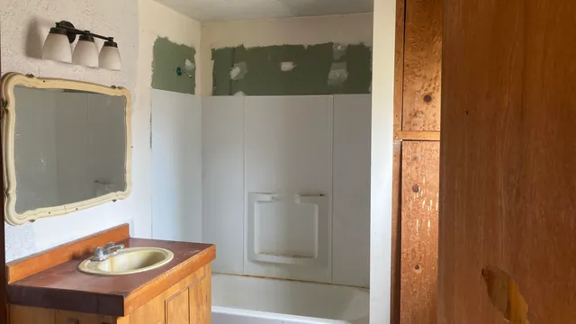 a bathroom with a sink and a mirror