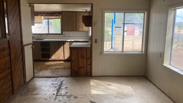 an empty room with windows and closet