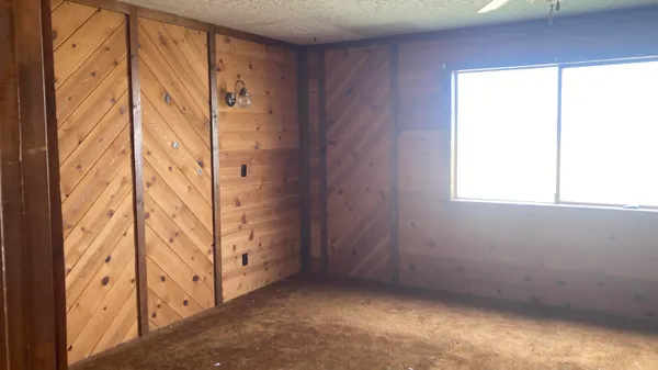 an empty room with a window and a door