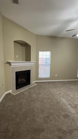 a view of empty room with a fireplace