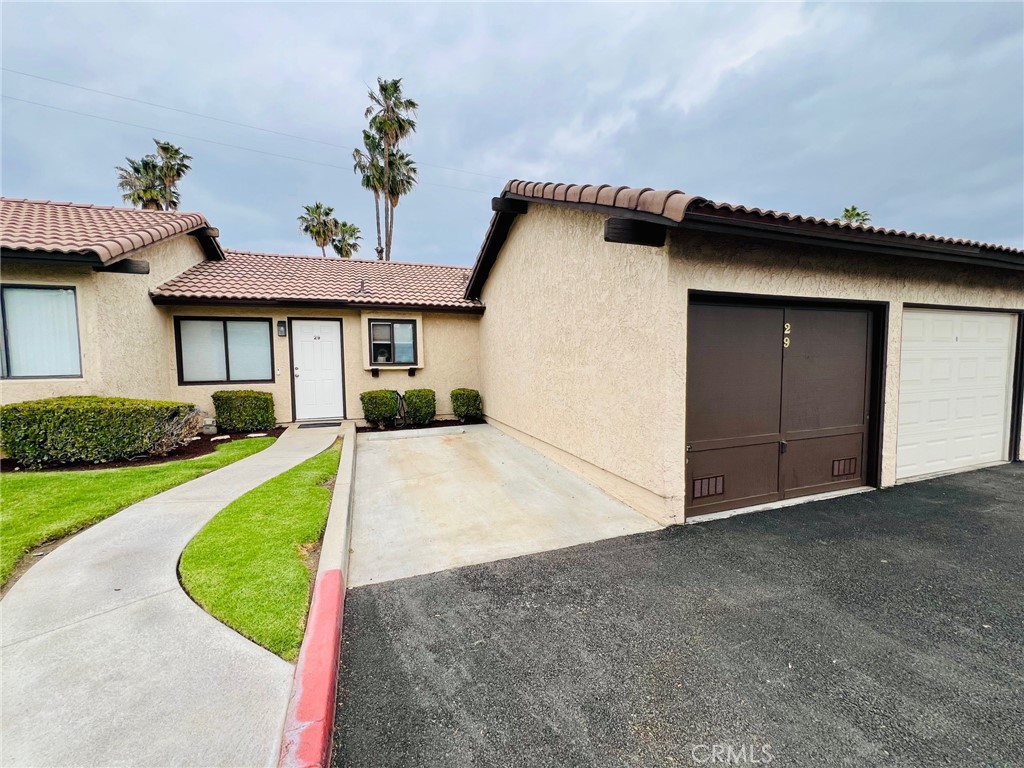 a view of a house with a yard and garage