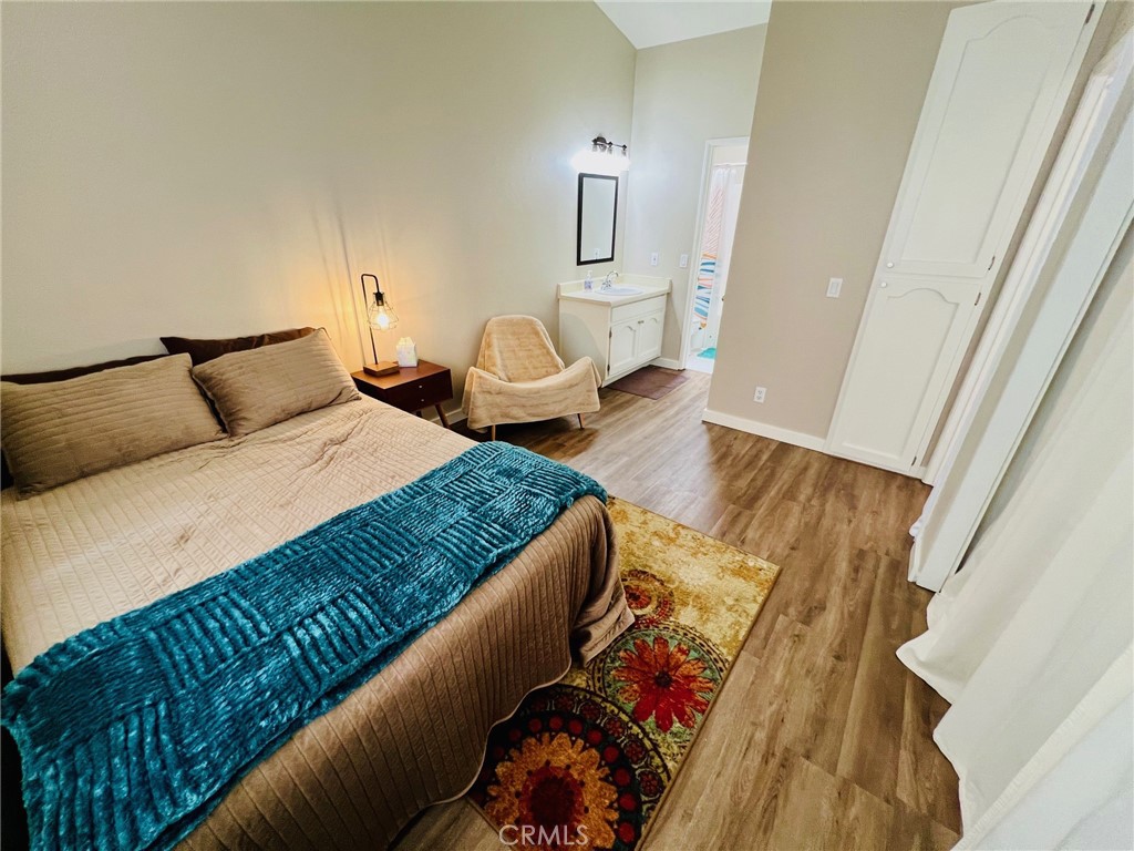 9505 Arlington Avenue, Unit 29 Riverside, CA 92503 - Photo 13 of 21 a bedroom with a bed and a mirror