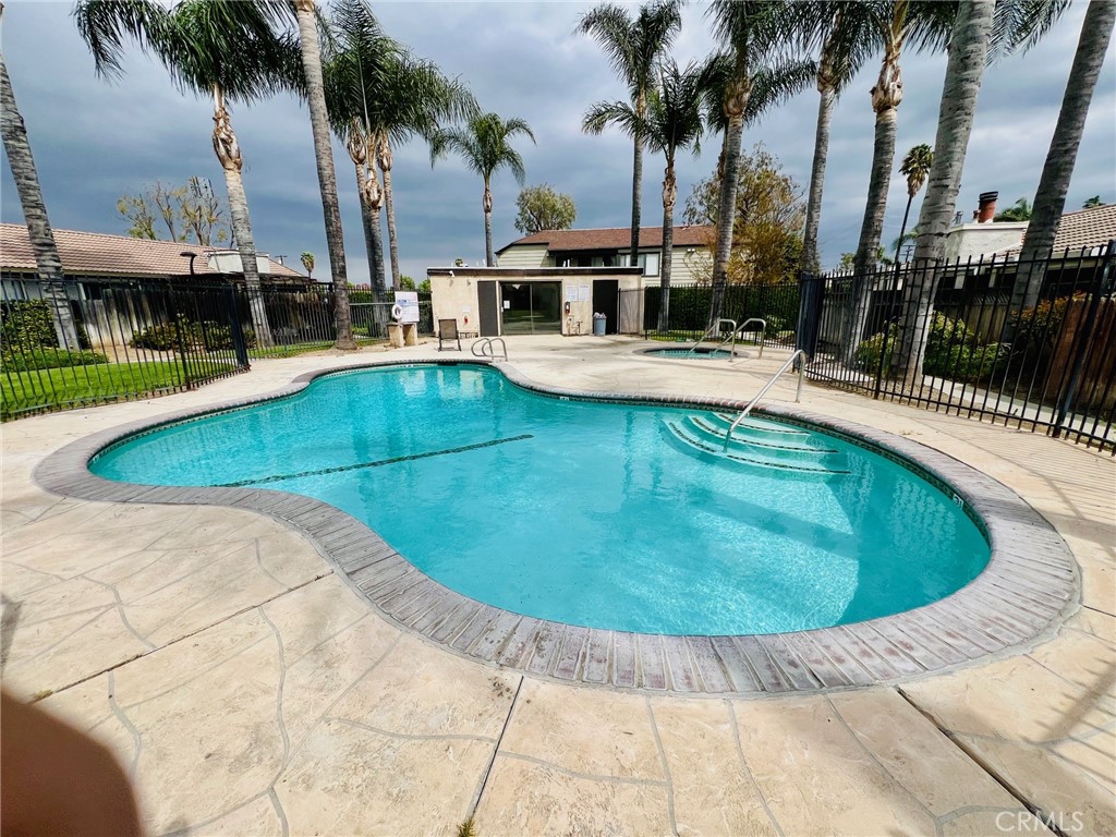 9505 Arlington Avenue, Unit 29 Riverside, CA 92503 - Photo 19 of 21 a view of swimming pool with outdoor seating and palm trees