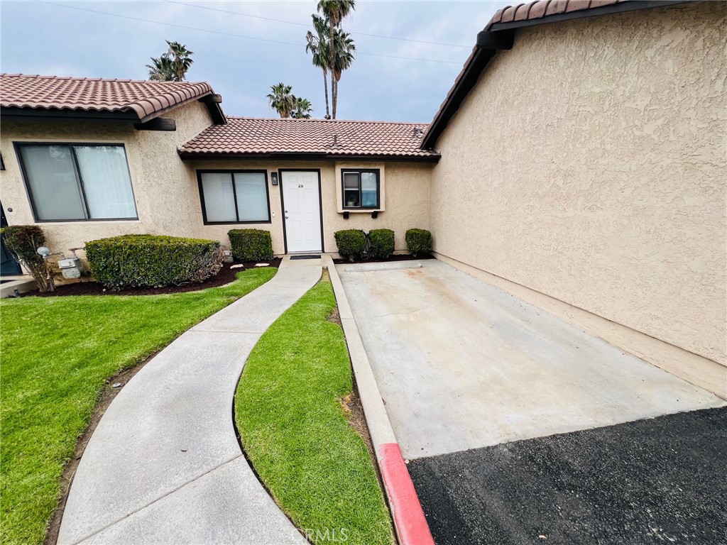 9505 Arlington Avenue, Unit 29 Riverside, CA 92503 - Photo 3 of 21 a front view of a house with a yard