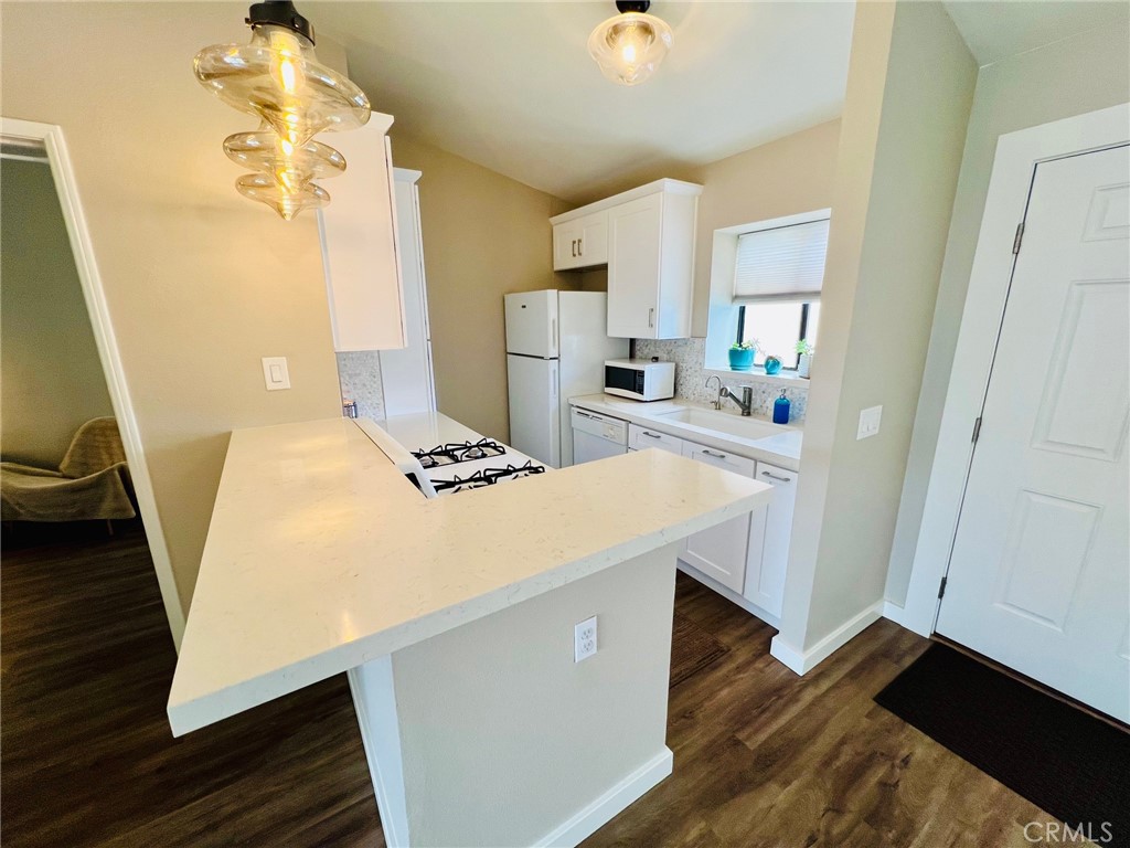 9505 Arlington Avenue, Unit 29 Riverside, CA 92503 - Photo 6 of 21 a kitchen with sink cabinets and wooden floor