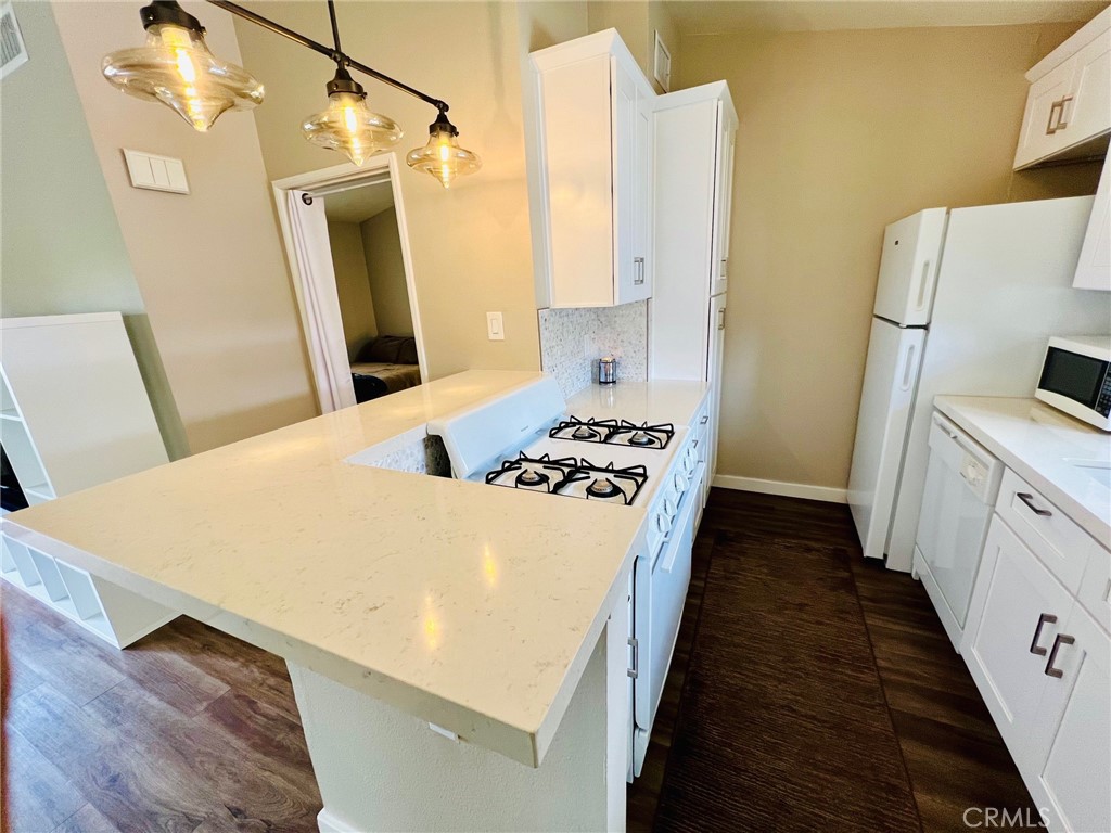 9505 Arlington Avenue, Unit 29 Riverside, CA 92503 - Photo 7 of 21 a kitchen with sink a refrigerator and a stove