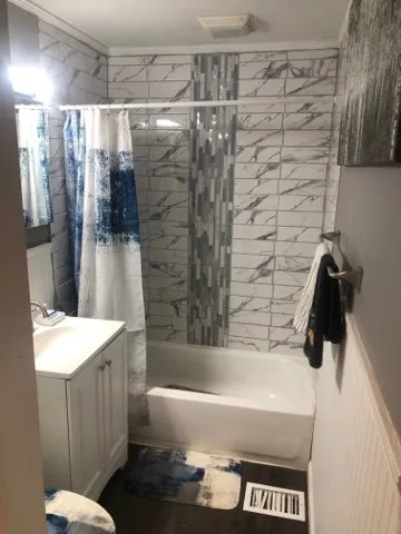 a bathroom with a bathtub and a sink