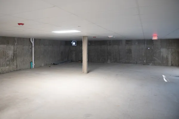 an empty room with an entryway and fan