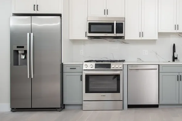 a kitchen with cabinets and stainless steel appliances