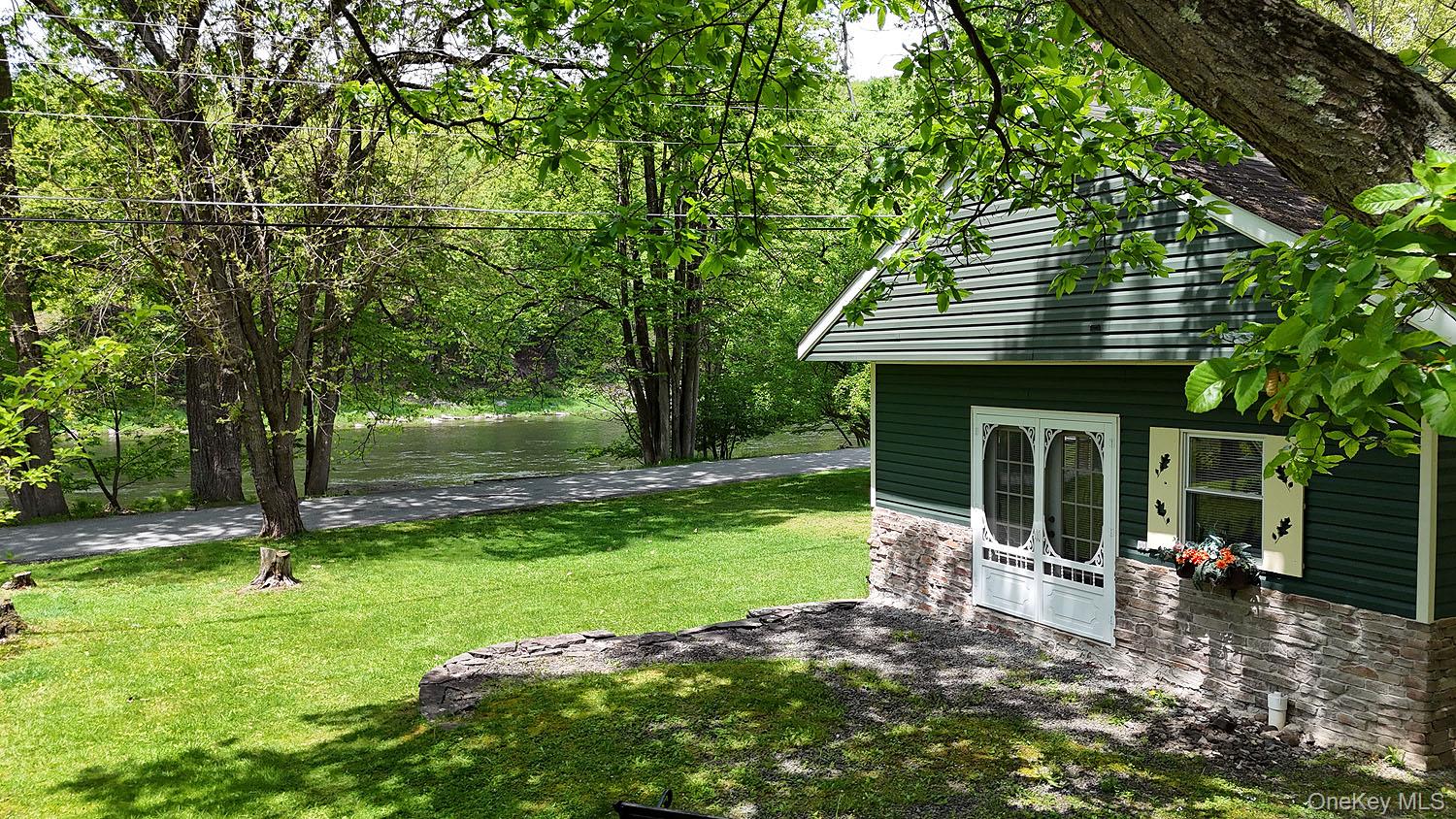 860 River Road Callicoon, NY 12723 - Photo 14 of 45 a backyard of a house with barbeque oven table and chairs
