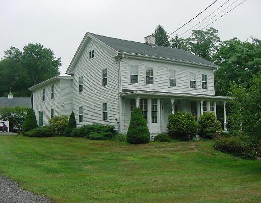 26 Wellers Bridge Road Roxbury, CT 06783 - Photo 1 of 1 a view of a white house next to a yard with potted plants