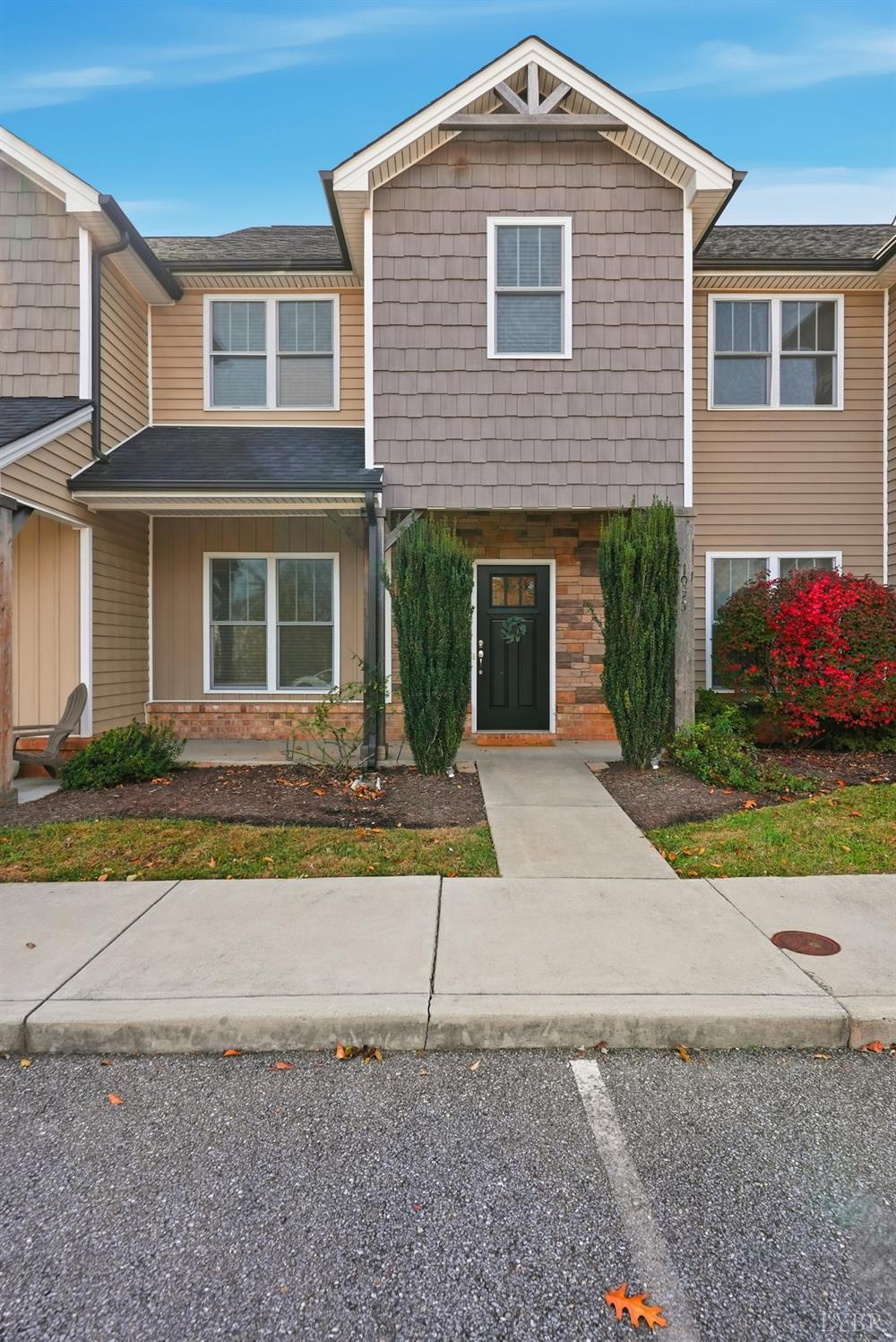 1057 Casley Way Forest, VA 24551 - Photo 24 of 27 a front view of a house with a yard and a garage
