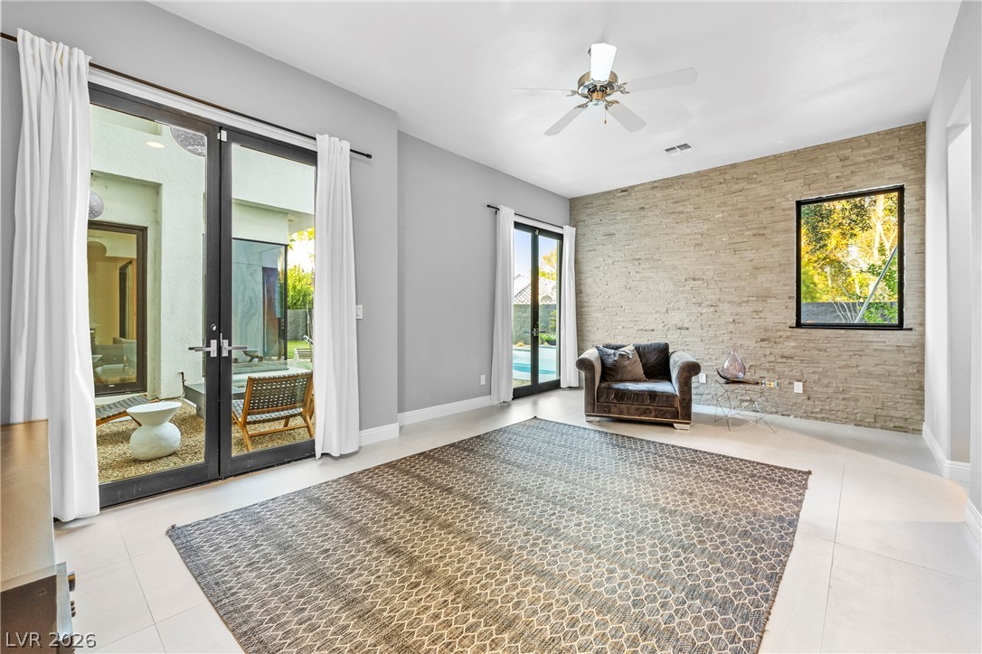 2000 Grouse Street Las Vegas, NV 89134 - Photo 12 of 89 Natural light floods this inviting living space, connecting seamlessly to outdoor leisure areas.