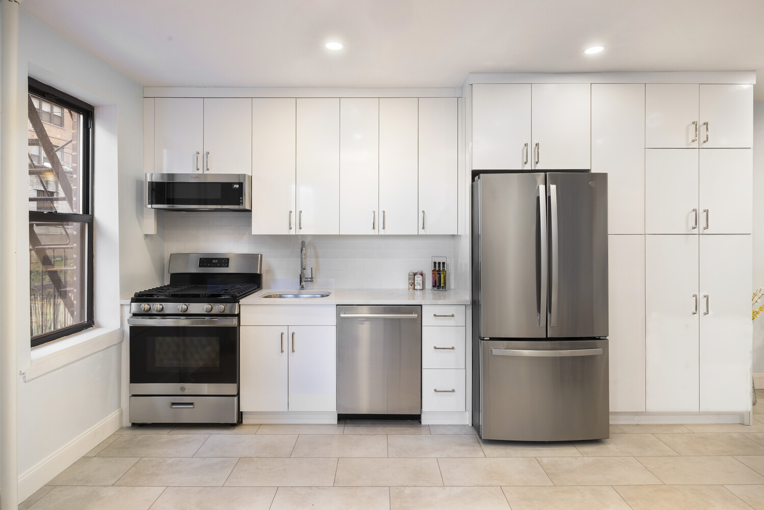 25 Indian Road, Unit 2A Manhattan, NY 10034 - Photo 3 of 11 a kitchen with a refrigerator stove and microwave