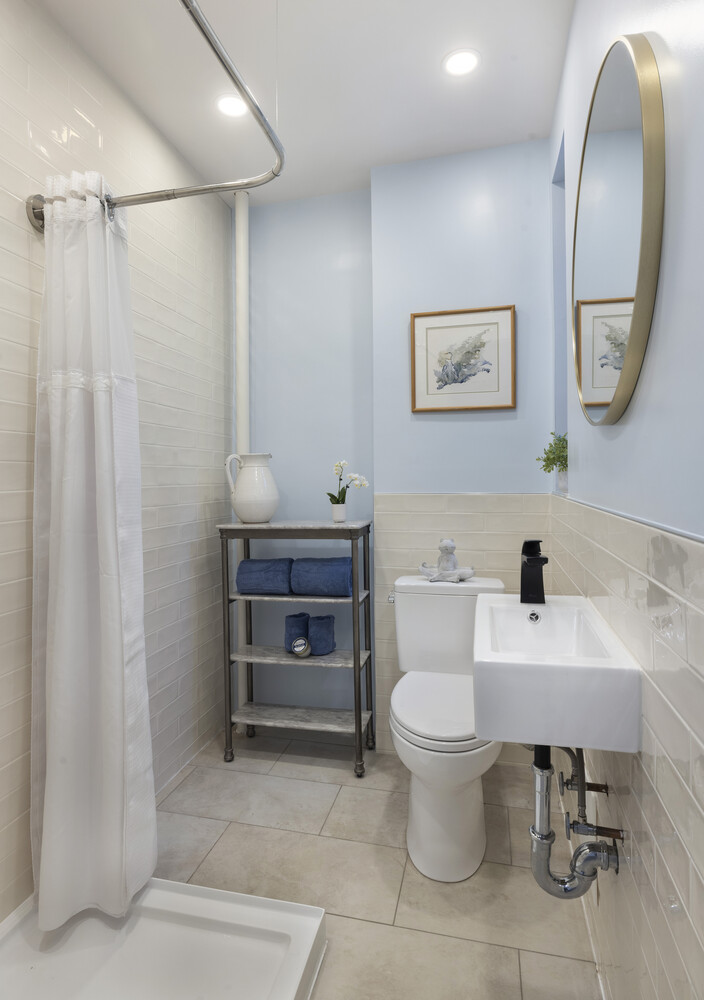 25 Indian Road, Unit 2A Manhattan, NY 10034 - Photo 7 of 11 a bathroom with a toilet a sink and a mirror