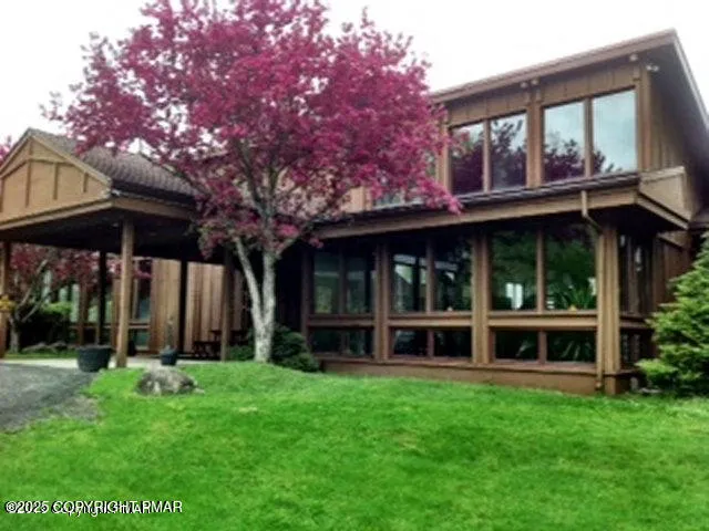 a view of house with yard front of house