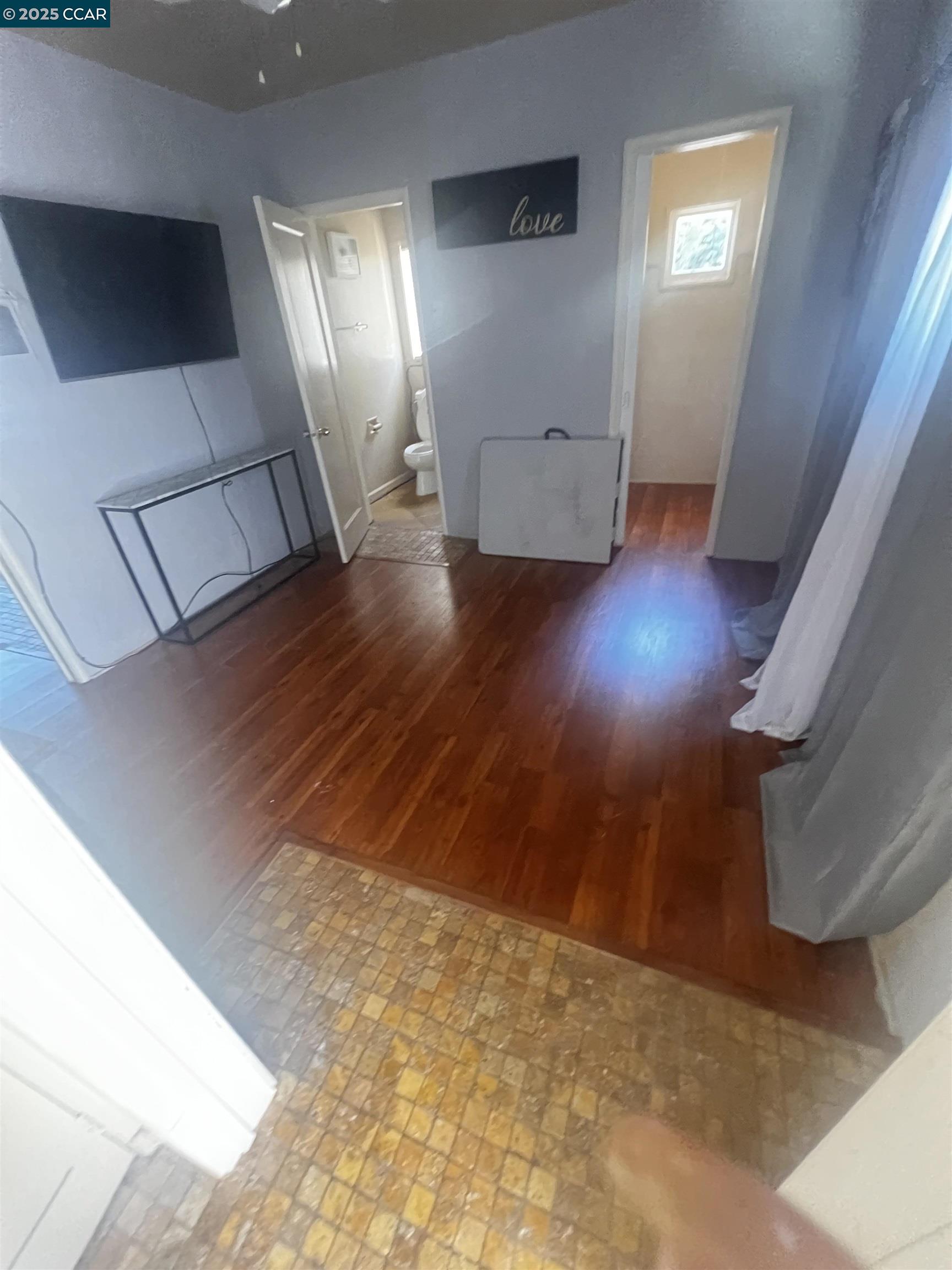 1161 64th Street Oakland, CA 94608 - Photo 16 of 34 a view of empty room with wooden floor