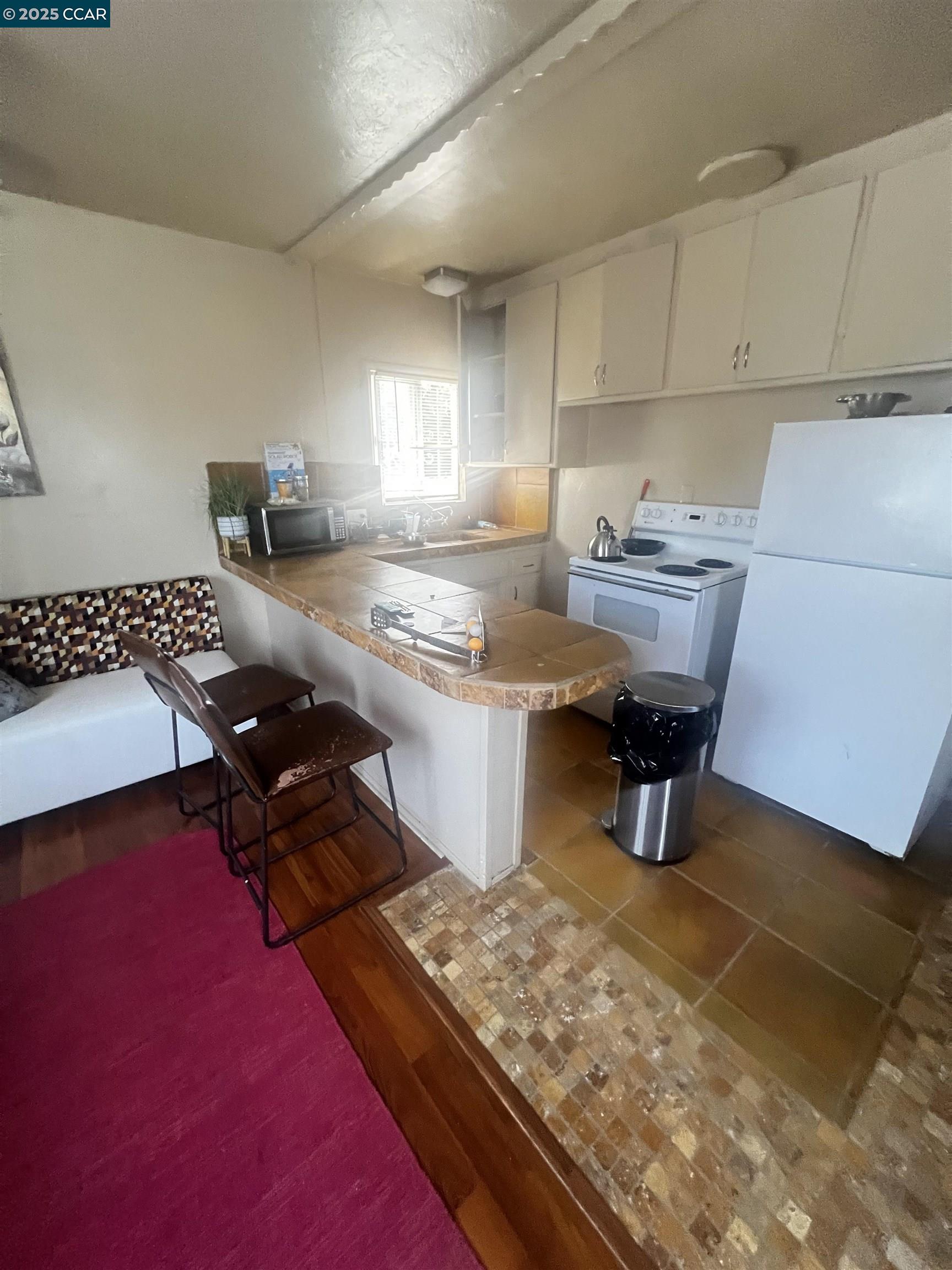 1161 64th Street Oakland, CA 94608 - Photo 17 of 34 a kitchen with a sink and a stove top oven
