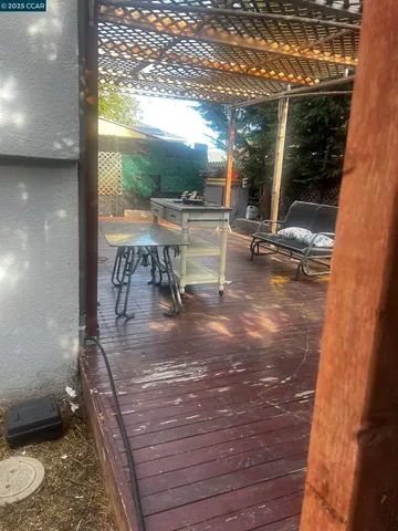 a view of a porch with a table and chairs