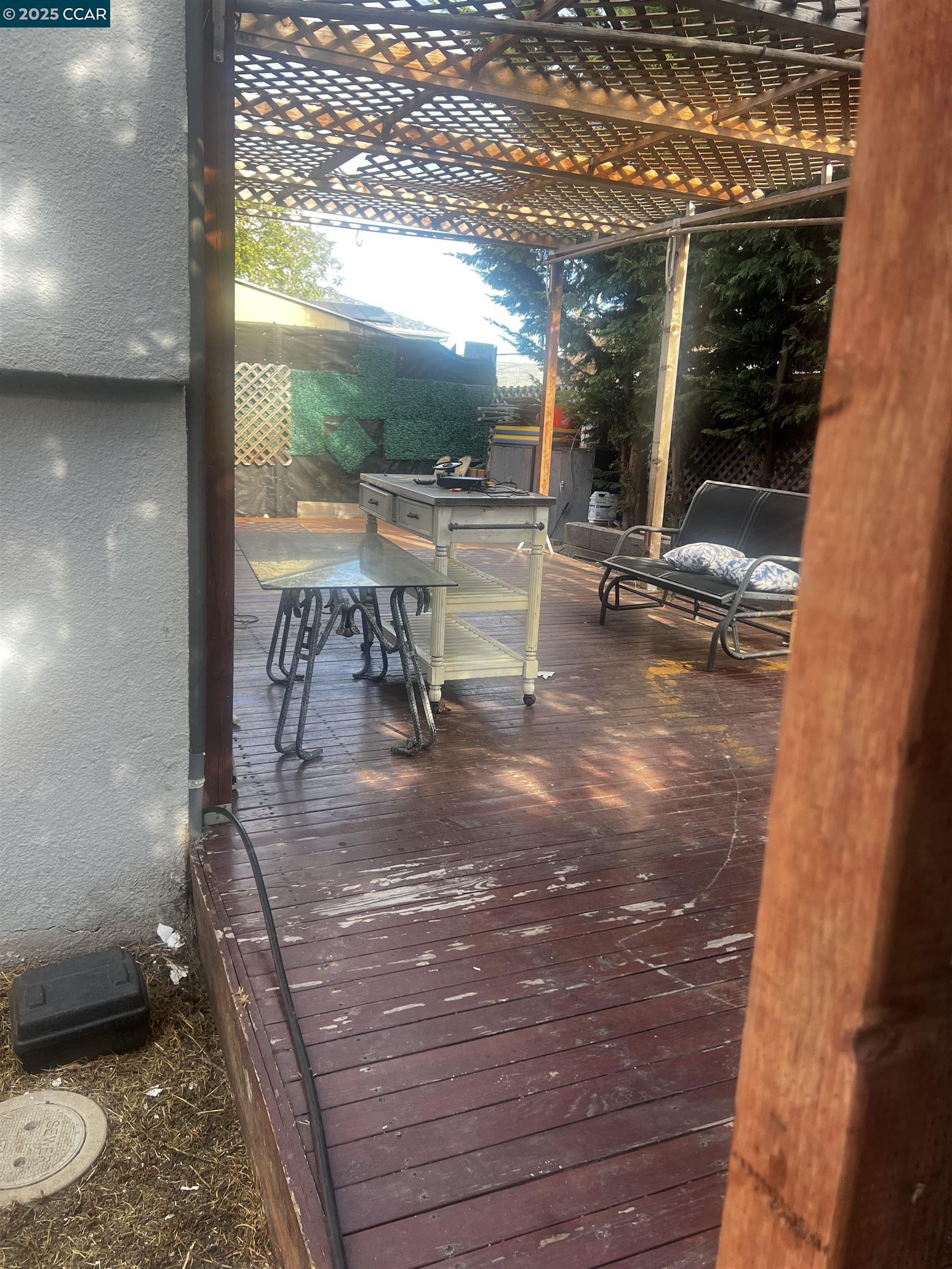 1161 64th Street Oakland, CA 94608 - Photo 2 of 34 a view of a porch with a table and chairs