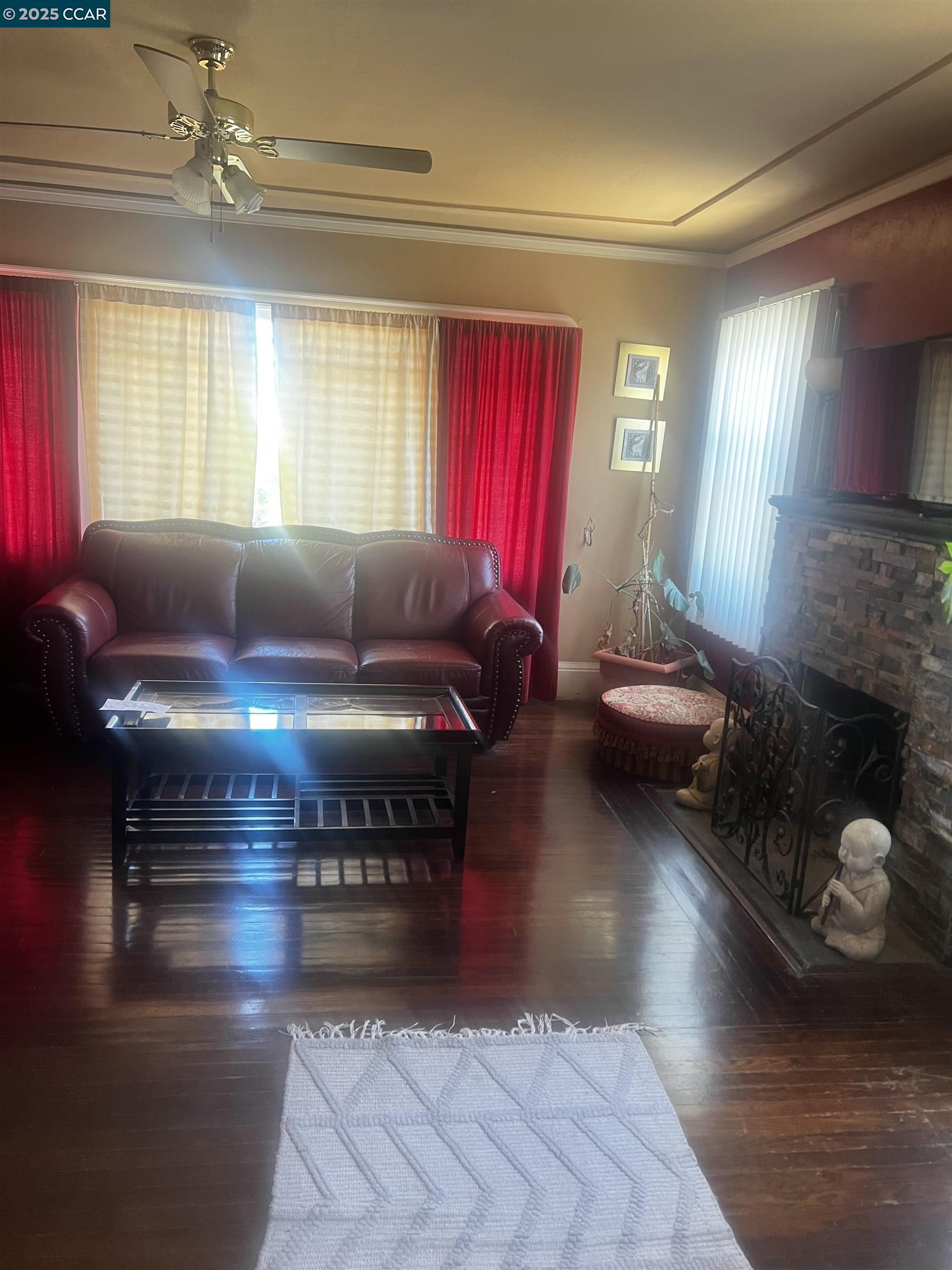 1161 64th Street Oakland, CA 94608 - Photo 26 of 34 a living room with furniture and a window
