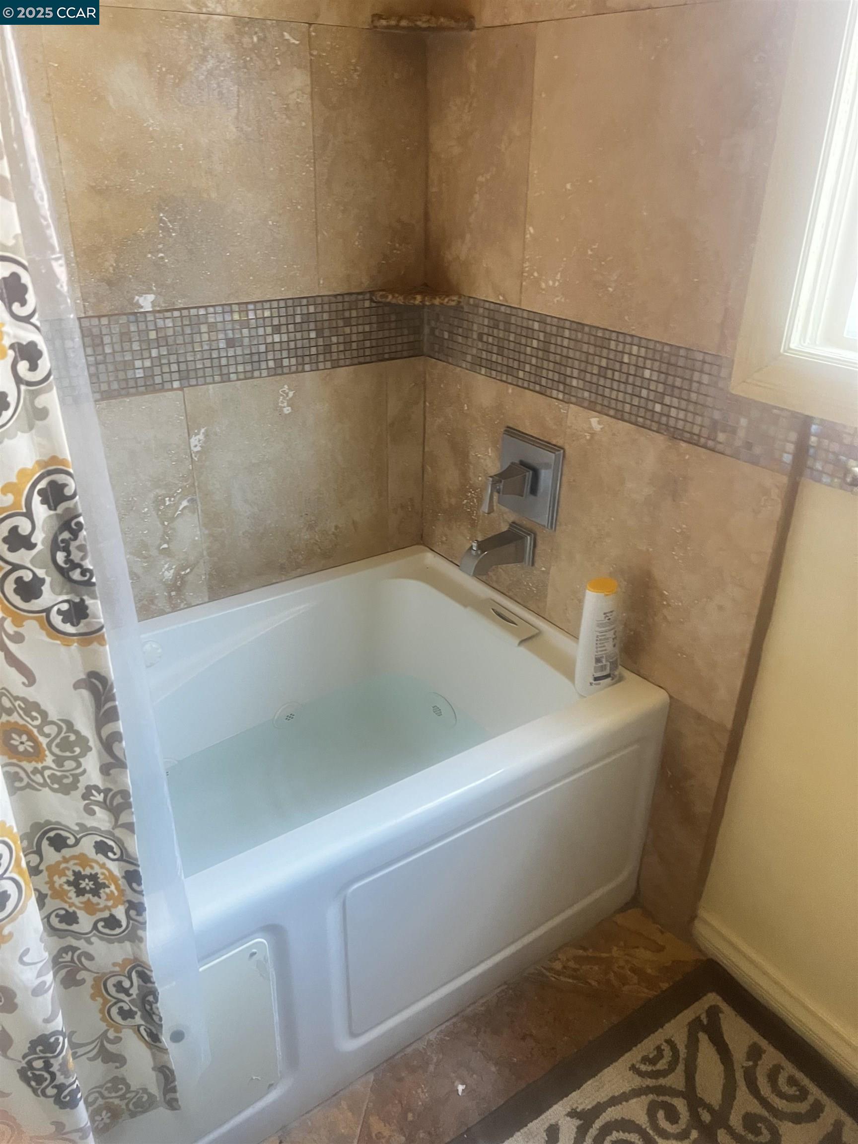 1161 64th Street Oakland, CA 94608 - Photo 30 of 34 a white bath tub sitting next to a toilet