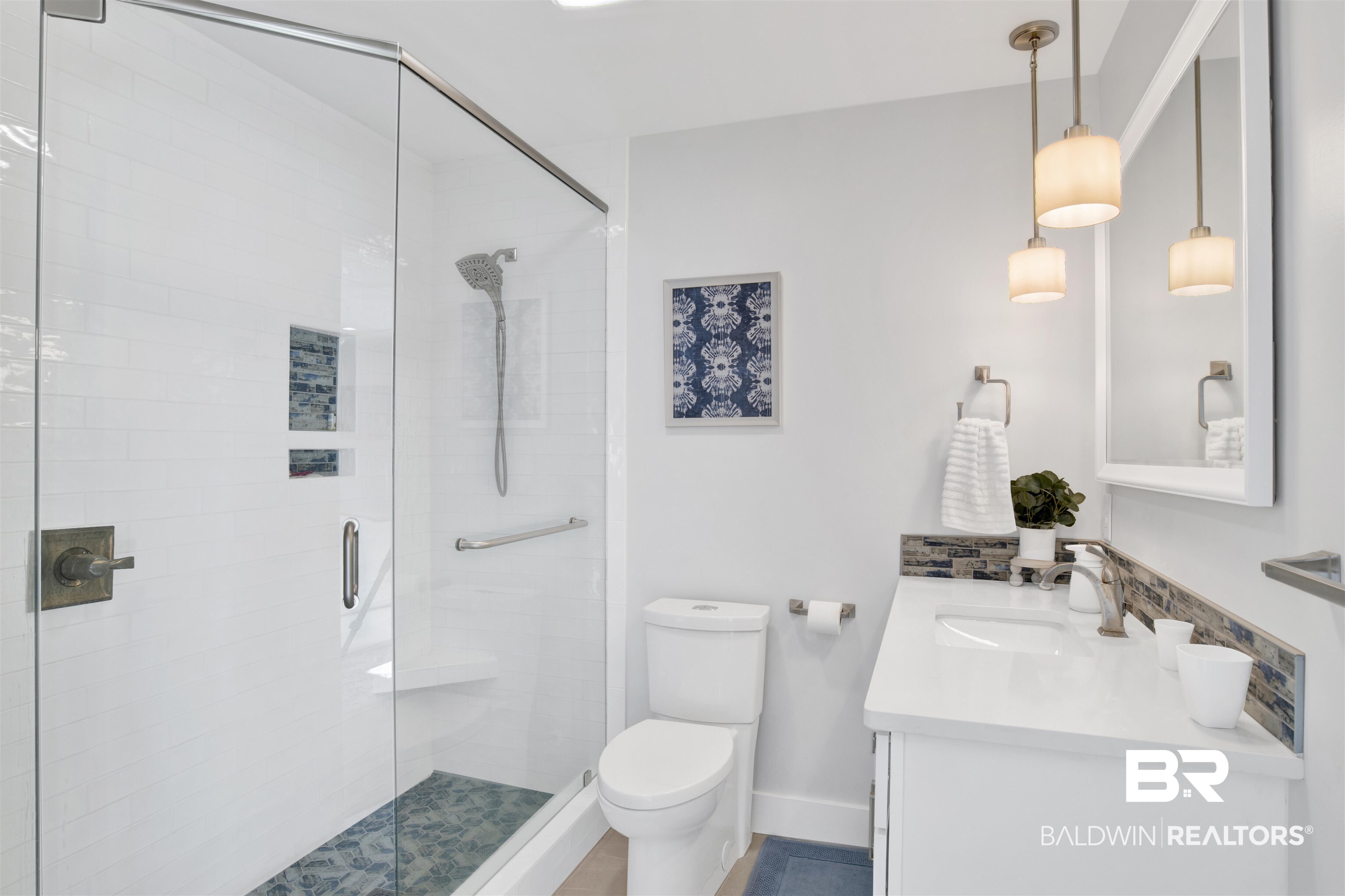32937 River Road Orange Beach, AL 36561 - Photo 29 of 42 Bathroom featuring vanity, toilet, and a shower with shower door