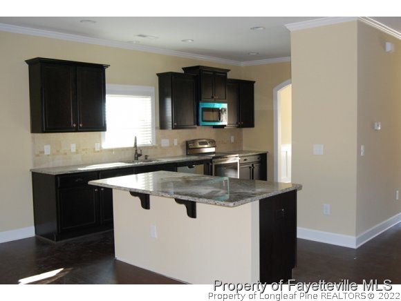 1014 Micahs Way North Spring Lake, NC 28390 - Photo 11 of 25 a kitchen with a sink dishwasher a stove and a refrigerator