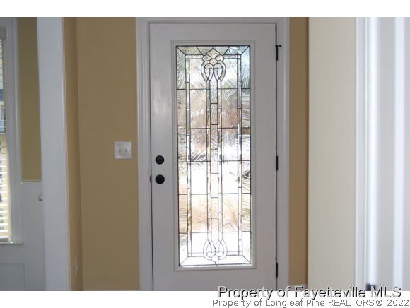 1014 Micahs Way North Spring Lake, NC 28390 - Photo 12 of 25 a view of an empty room with wooden floor and a window