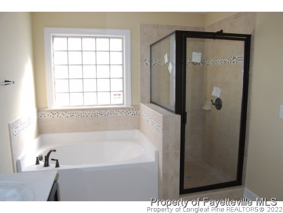 1014 Micahs Way North Spring Lake, NC 28390 - Photo 17 of 25 a bathroom with a bathtub and a sink
