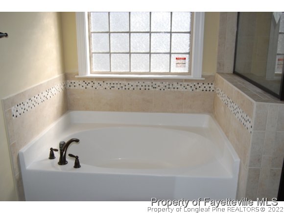 1014 Micahs Way North Spring Lake, NC 28390 - Photo 18 of 25 a bathroom with a bathtub