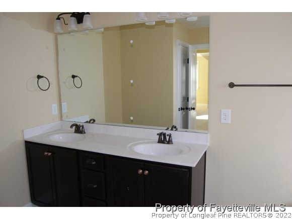 1014 Micahs Way North Spring Lake, NC 28390 - Photo 19 of 25 a bathroom with a sink and a mirror