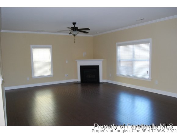 1014 Micahs Way North Spring Lake, NC 28390 - Photo 7 of 25 a view of empty room with wooden floor and fan
