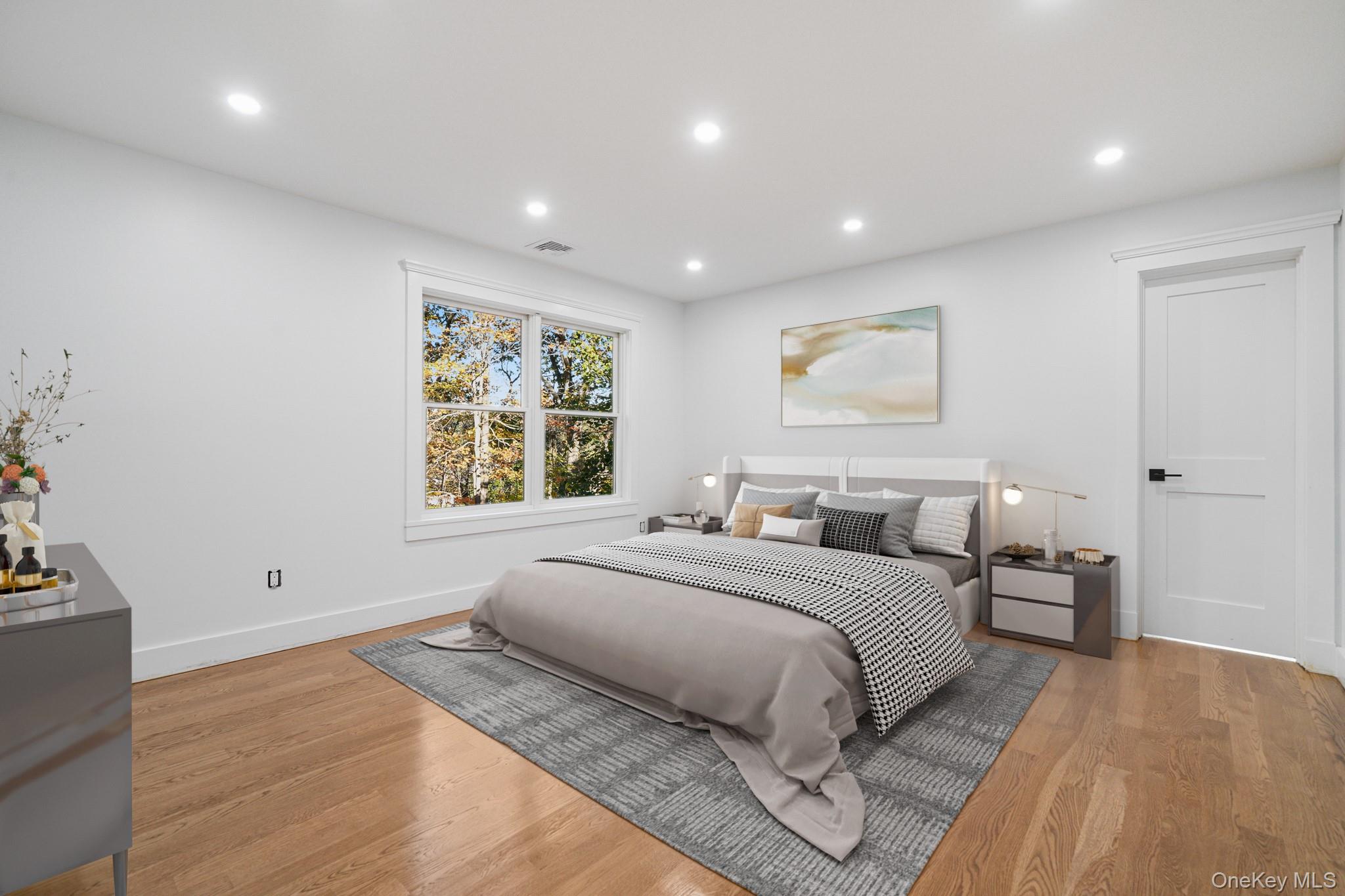 16 Bramblebrook Road Ardsley, NY 10502 - Photo 12 of 32 a bedroom with a large bed and a large window