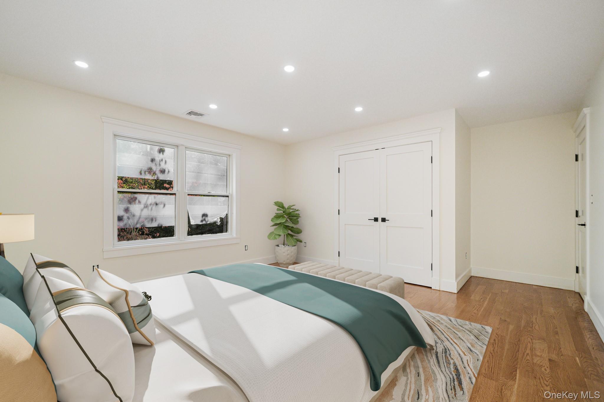 16 Bramblebrook Road Ardsley, NY 10502 - Photo 15 of 32 a bedroom with a bed and a painting on the wall