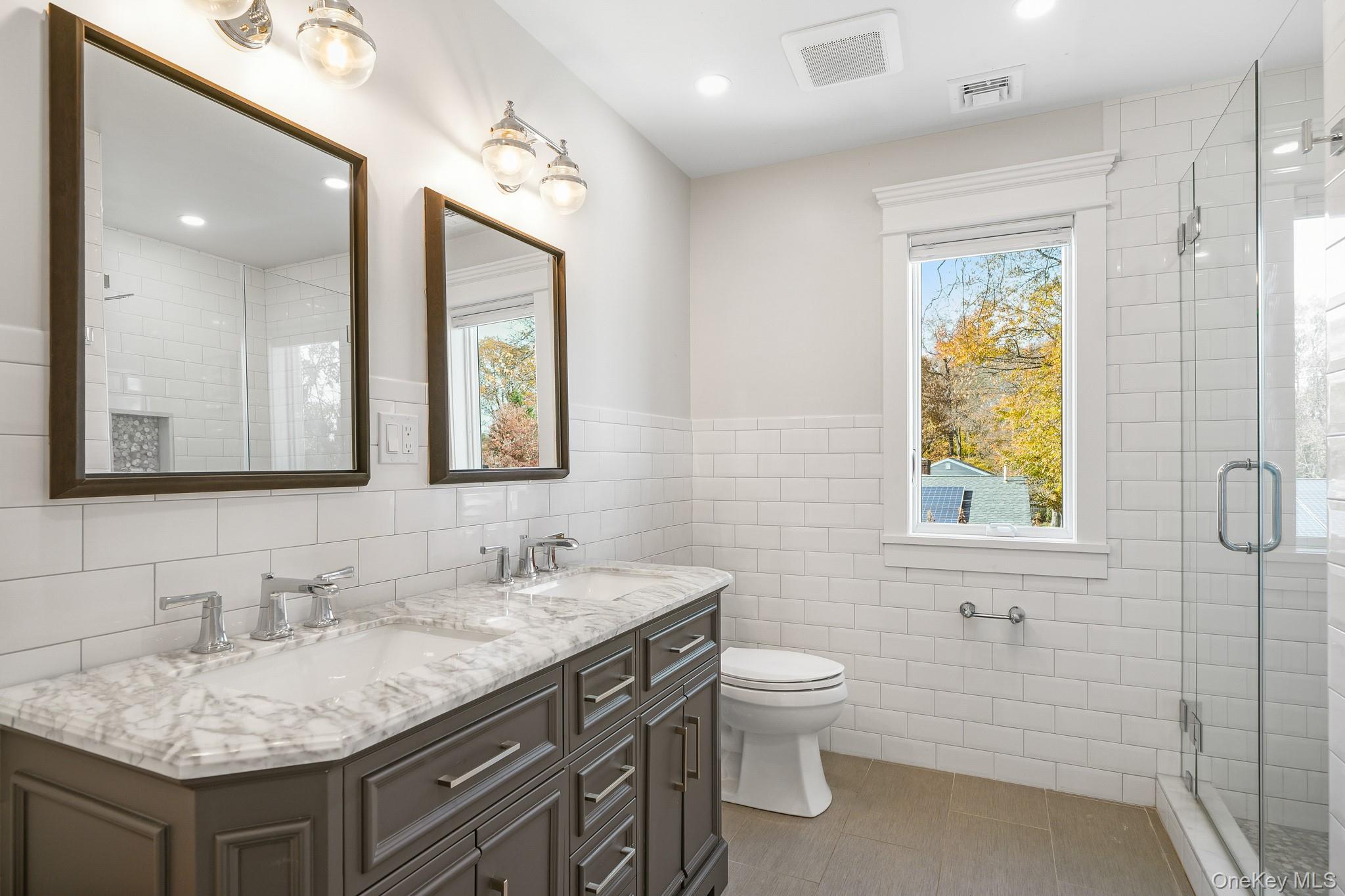 16 Bramblebrook Road Ardsley, NY 10502 - Photo 29 of 32 a bathroom with a granite countertop double vanity sink toilet and a mirror