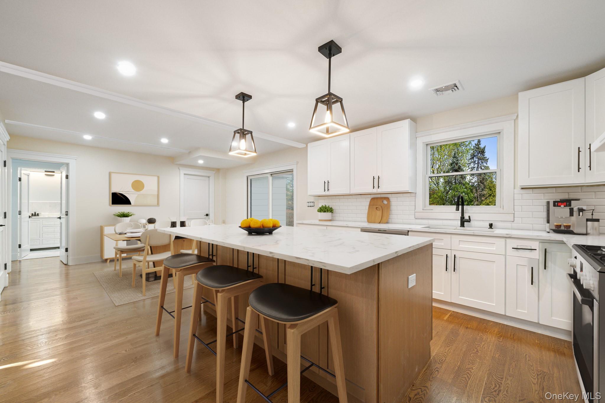 16 Bramblebrook Road Ardsley, NY 10502 - Photo 8 of 32 a kitchen with a table chairs stove and white cabinets
