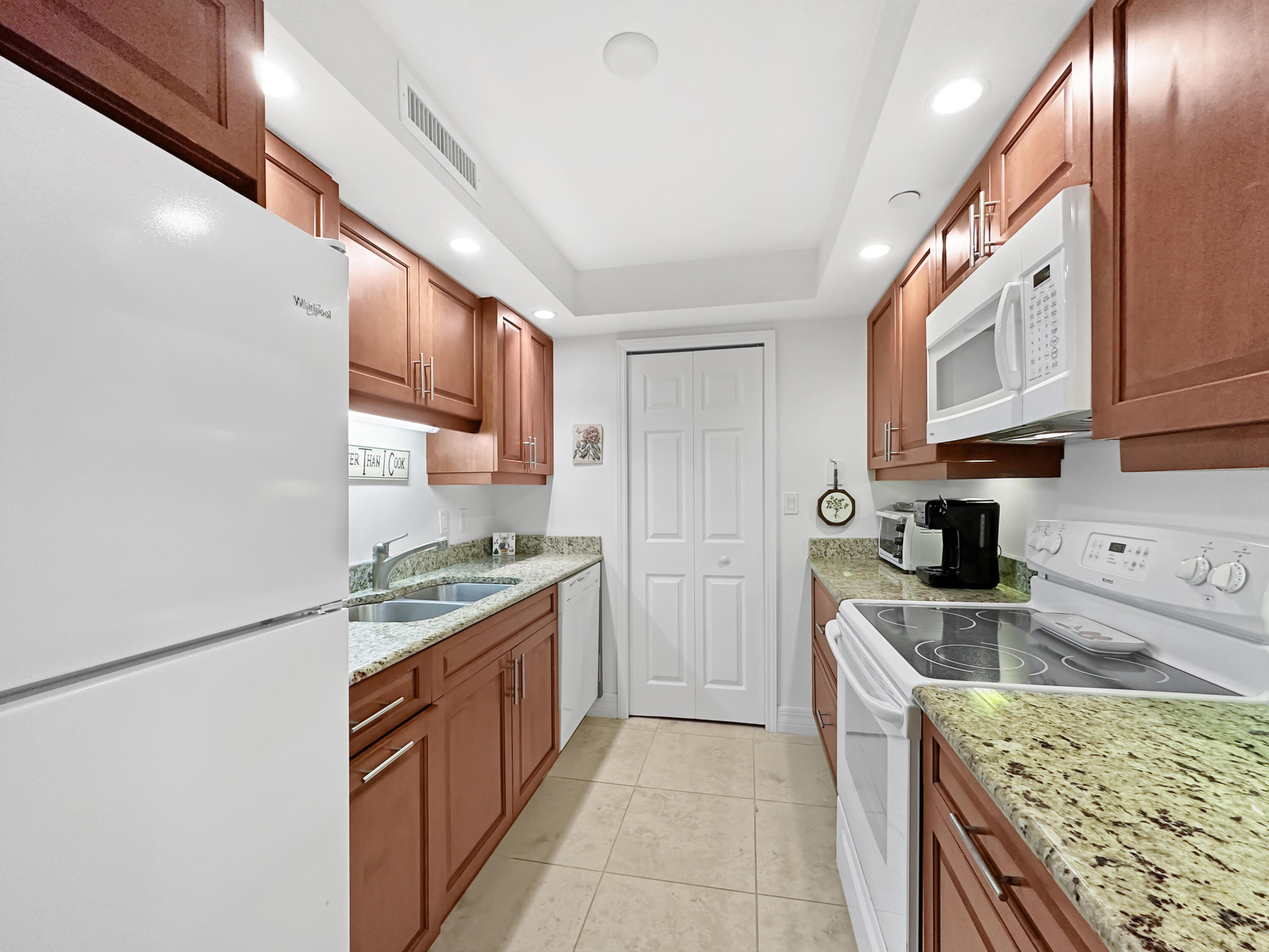 3000 North Ocean Drive, Unit 6B Singer Island, FL 33404 - Photo 3 of 47 a kitchen with stainless steel appliances granite countertop a stove a sink dishwasher and a refrigerator