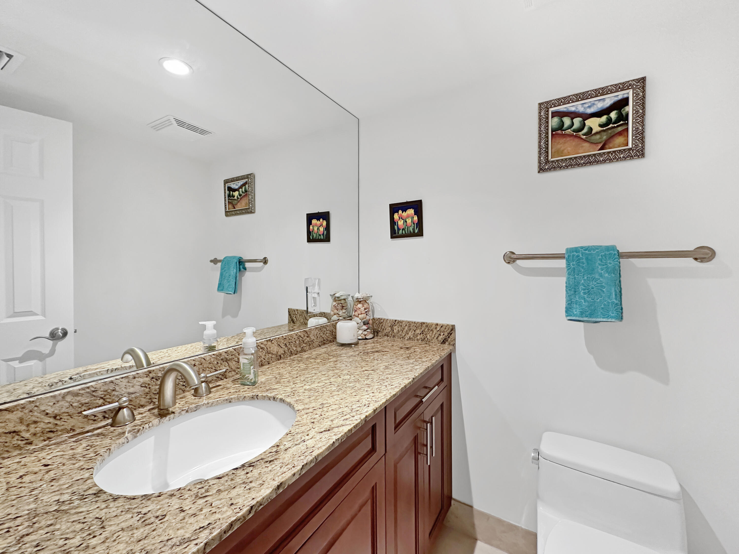 3000 North Ocean Drive, Unit 6B Singer Island, FL 33404 - Photo 10 of 47 a bathroom with a granite countertop sink a mirror and a toilet