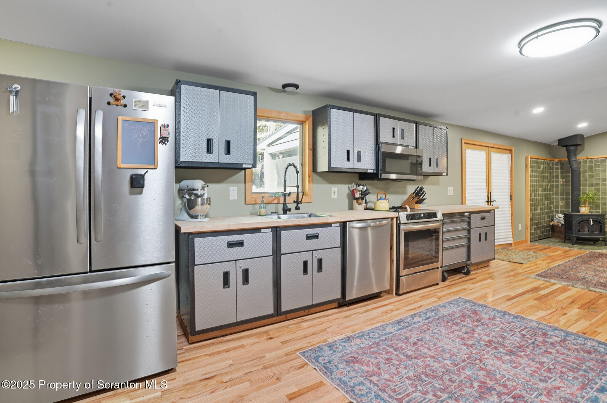 452 Engvaldsen Road Hawley, PA 18428 - Photo 11 of 42 a kitchen with stainless steel appliances granite countertop a refrigerator sink and stove