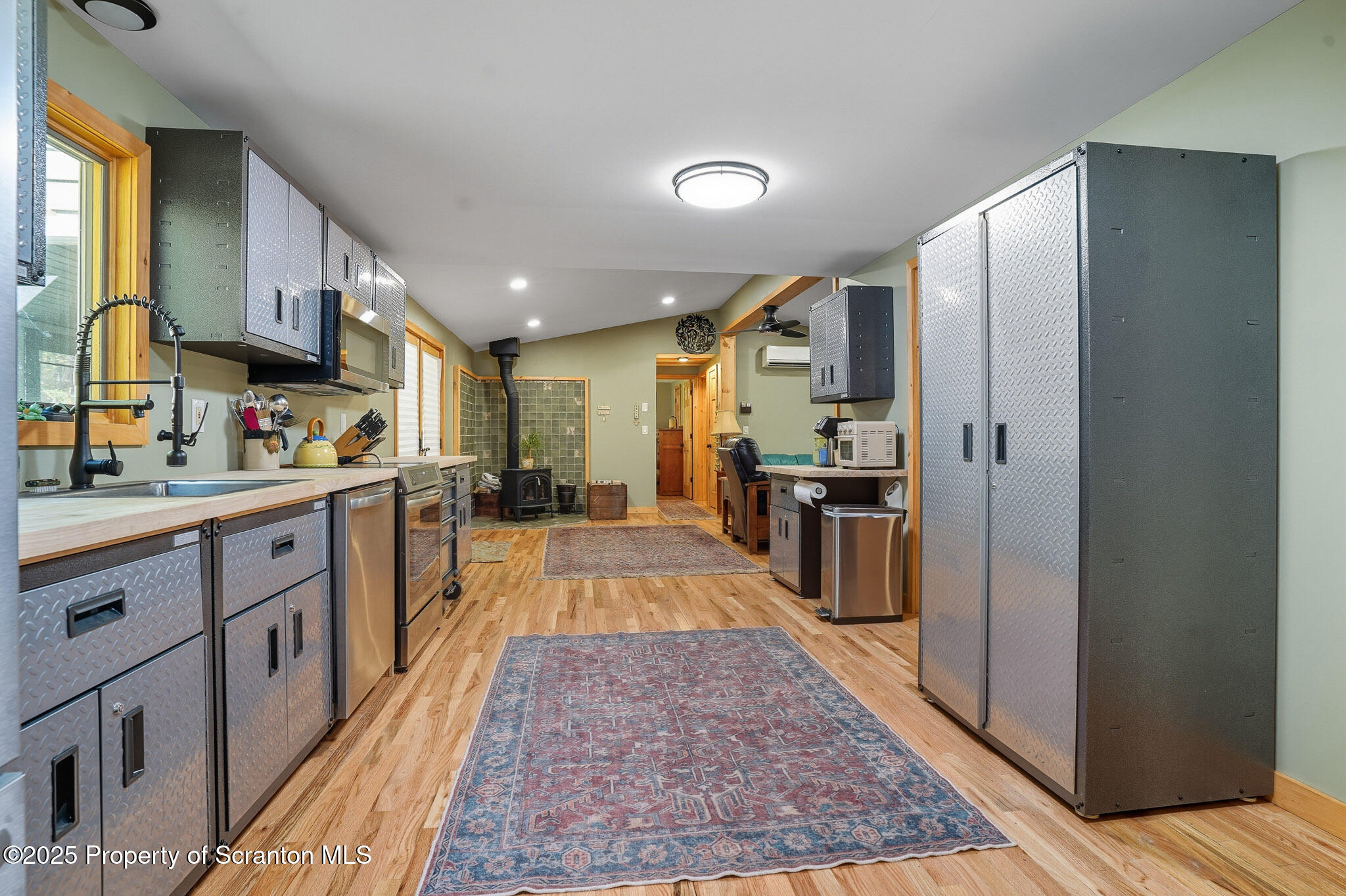 452 Engvaldsen Road Hawley, PA 18428 - Photo 12 of 42 a large kitchen with stainless steel appliances granite countertop a refrigerator and a sink