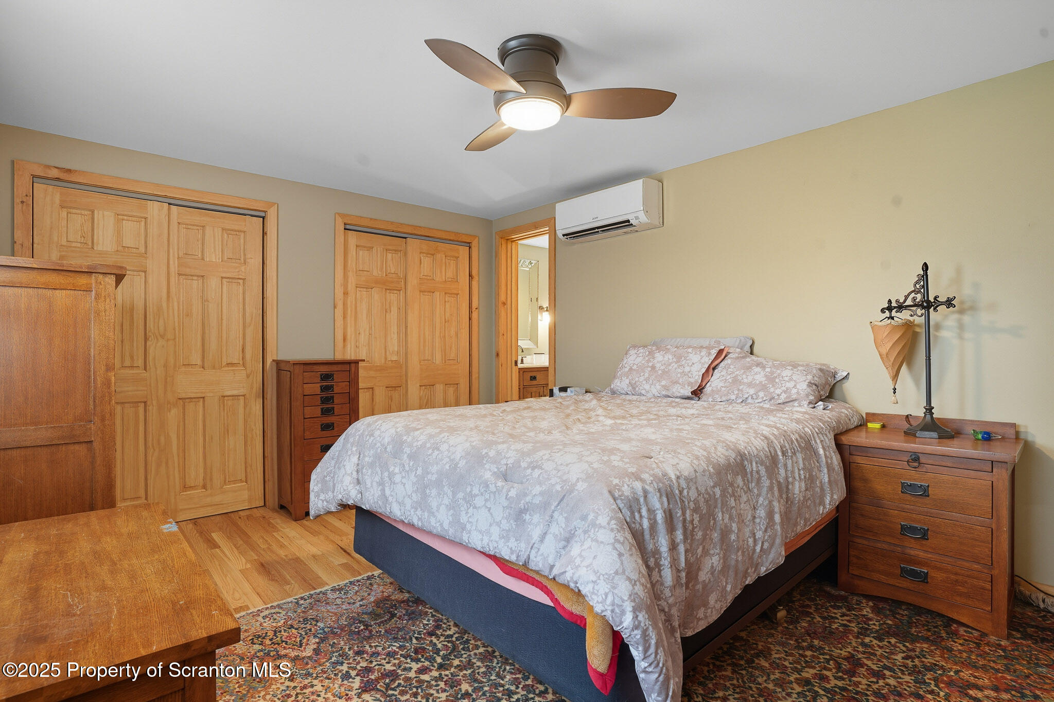 452 Engvaldsen Road Hawley, PA 18428 - Photo 23 of 42 a bedroom with a bed and a dresser