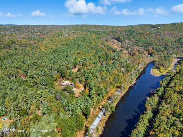 an aerial view of a houses with a yard