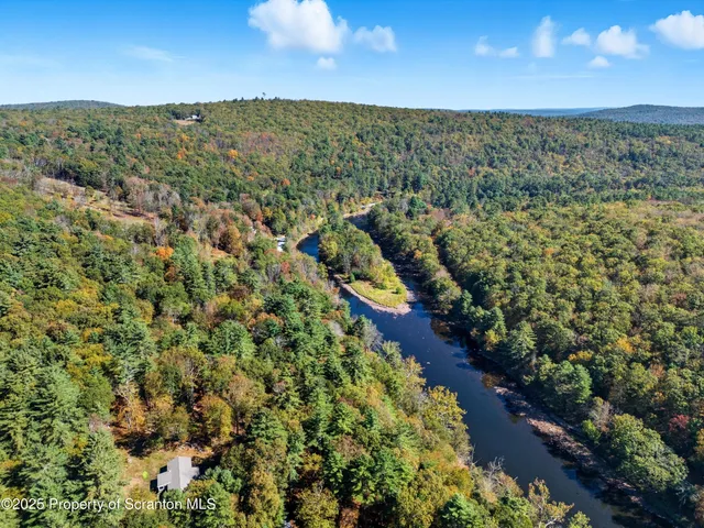 a view of a wooden deck with chairs and a yard