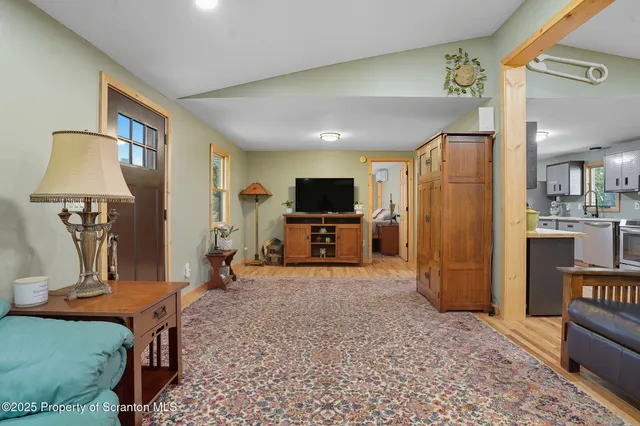 a view of a livingroom with furniture and a flat screen tv